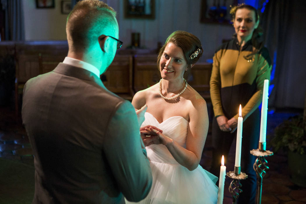 Stephen Goetz puts a ring on the finger of his new wife, Kristin Perry, during their Star Trek-themed wedding of at the Viva Las Vegas Wedding Chapel on Saturday, June 3, 2017.  Patrick Connolly L ...