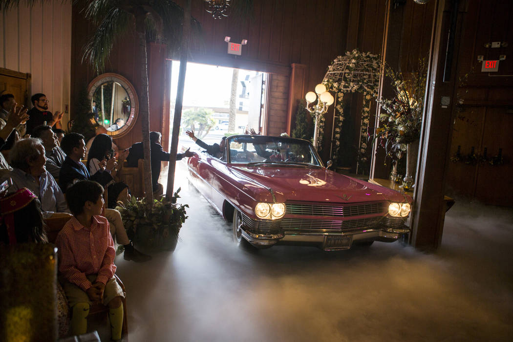 Ron Decar, owner of Viva Las Vegas, makes his appearance as Elvis while driving Garry and Julie Kim into the chapel to renew their wedding vows at the Viva Las Vegas Wedding Chapel on Saturday, Ju ...