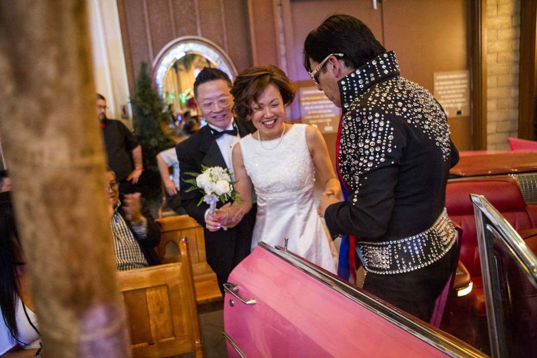 Ron Decar, owner of Viva Las Vegas, helps Julie and Garry Kim out of the pink Cadillac and into the chapel to renew their wedding vows at the Viva Las Vegas Wedding Chapel on Saturday, June 3, 201 ...