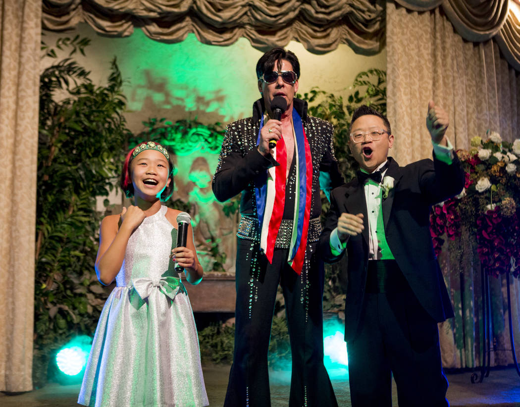 Garry Kim cheers with his daughter Lola during their Elvis-themed ceremony to renew their wedding vows at the Viva Las Vegas Wedding Chapel on Saturday, June 3, 2017.  Patrick Connolly Las Vegas R ...