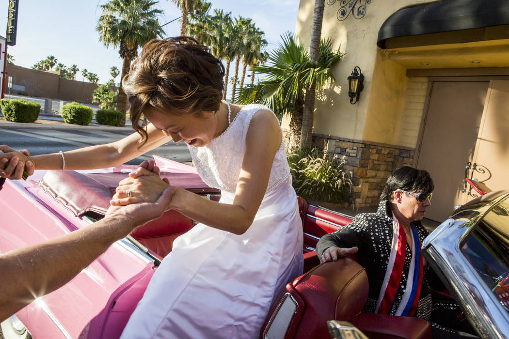 Julie Kim is helped out of the pink Cadillac after renewing her wedding vows with Garry Kim at the Viva Las Vegas Wedding Chapel on Saturday, June 3, 2017.  Patrick Connolly Las Vegas Review-Journ ...