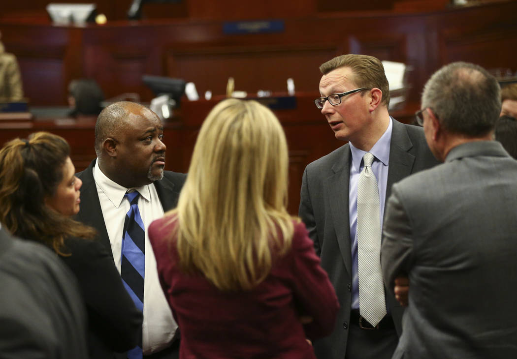Assembly Speaker Jason Frierson, D-Las Vegas, second from left, and Sen. Ben Kieckhefer, R-Reno, fourth from left, in the Assembly Chambers at the Legislative Building in Carson City during the ea ...