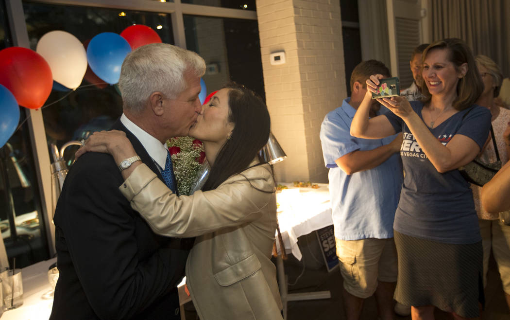 Las Vegas city council candidate Col. Steve Seroka shares a kiss with his wife Nancy Wong during his election result party at Andiron Steak and Sea in Las Vegas on Tuesday, June 13, 2017. Richard  ...