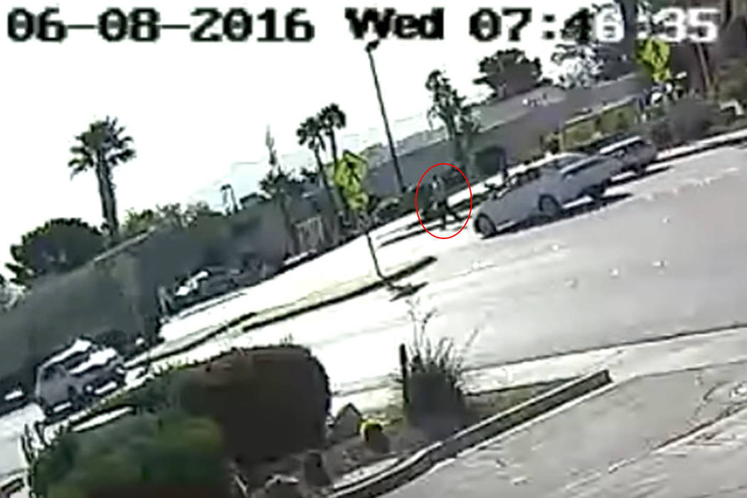 This screenshot from YouTube surveillance video shows John Hunt, inside the red circle, at a crosswalk in Boulder City on June 8, 2016. (YouTube)