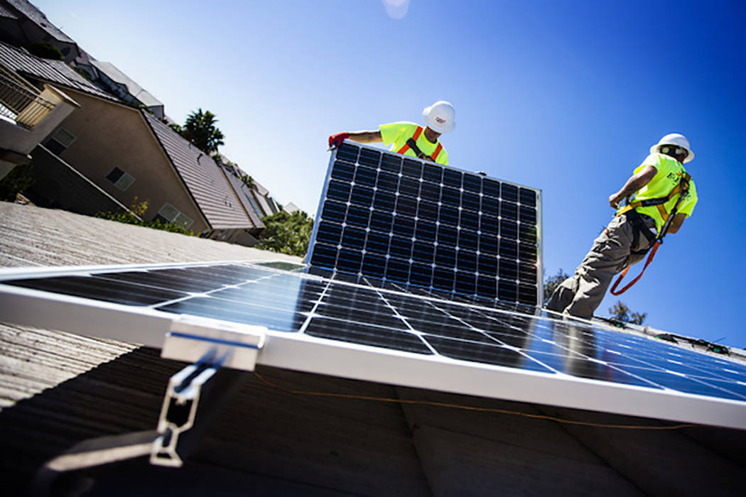 Matt Neifeld,left, and Jacy Sparkman with Robco Electric installs solar panels at a home in northwest Las Vegas on Friday March 13, 2015. Jeff Scheid Las Vegas Review-Journal
