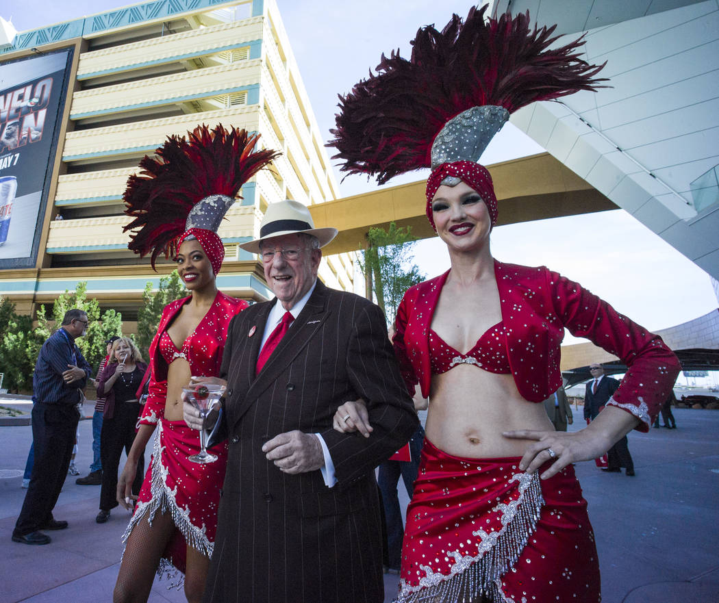 Oscar Goodman, with showgirls Trisha Thompson, left, and Kristina Schiavi for a rally celebrating National Travel & Tourism Week at Toshiba Plaza in Las Vegas on Tuesday, May 3, 2016. Chase St ...