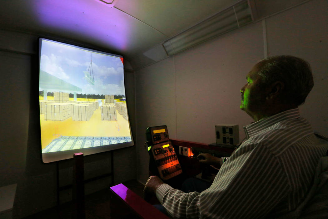 Louis Loupias, coordinator of the Southern Nevada Operating Engineers JATC, demonstrates a crane training simulator at William C. Waggoner Training Center in Las Vegas, Wednesday, May 24, 2017. Ch ...