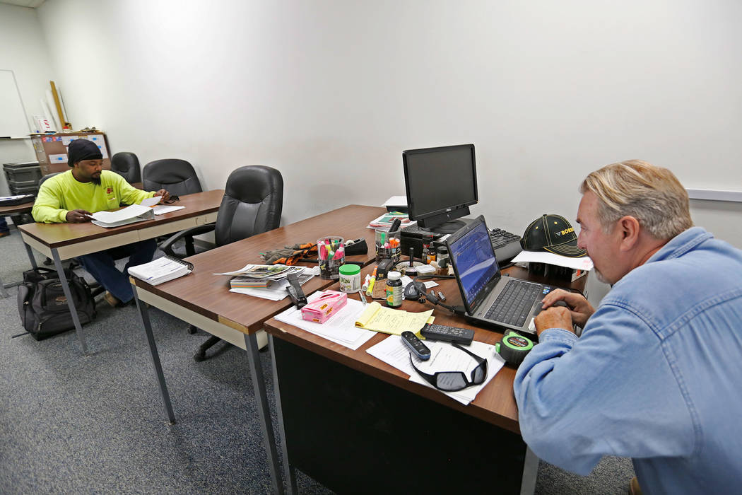 Apprentice Isaiah Hawkins of Las Vegas and his instructor Chris Trolson in grade checking class, a part of the apprenticeship program, at William C. Waggoner Training Center in Las Vegas, Wednesd ...