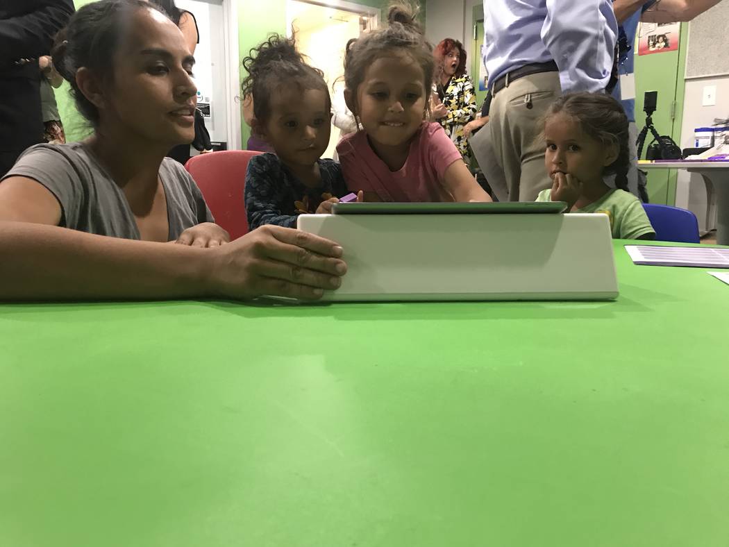 Veronica Martinez and daughters Alexandria, 3, and 5-year-old twins Isabelle and Crystal demonstrate Square Panda's multi-sensory phonics learning system for early literacy skills June 6 at Shade ...