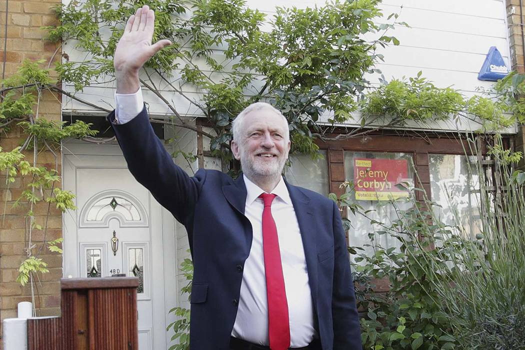 Labour leader Jeremy Corbyn waves as he leaves his home in north London, Friday June 9, 2017. British Prime Minister Theresa May's gamble in calling an early general election backfired spectacular ...