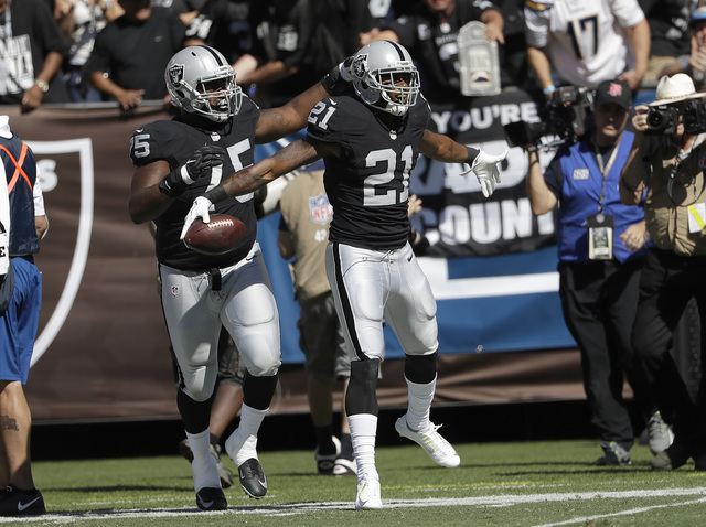 Oakland Raiders cornerback Sean Smith (21) celebrates after intercepting a pass against the San Diego Chargers during the first half of an NFL football game in Oakland, Calif., Sunday, Oct. 9, 201 ...