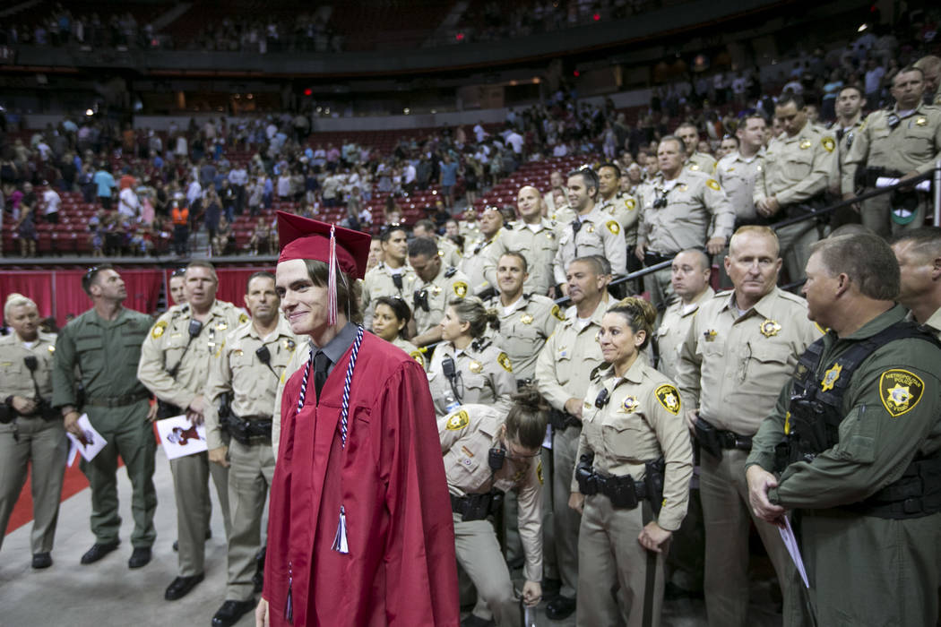 Daxton Beck, the son of slained Metro Officer Alyn Beck, gathers for photos with Metro Officers following his graduation ceremony at Thomas and Mack in Las Vegas on Saturday, June 10, 2017. Richar ...