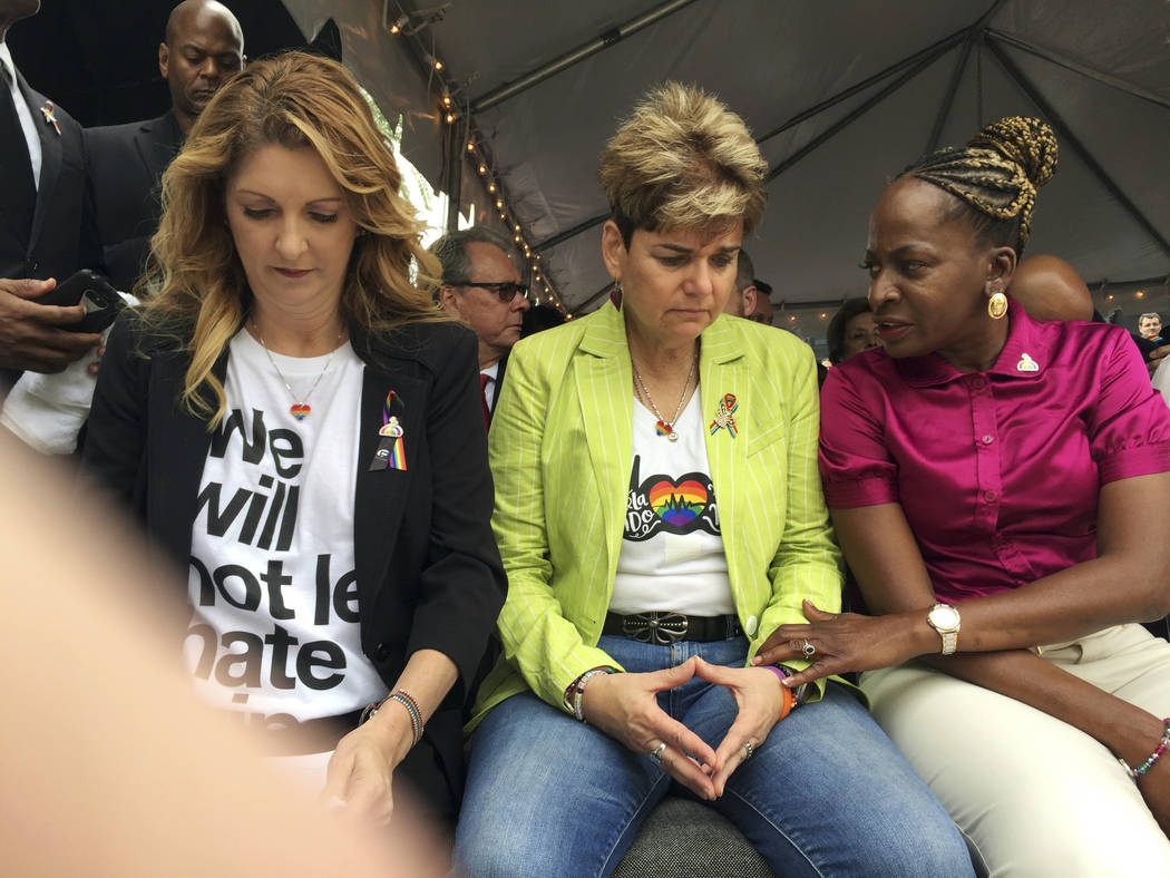 Barbara Poma, from left, owner of Pulse nightclub, Patty Sheehan, city commissioner, and Regina Hill, city commissioner, attend a public remembrance ceremony Monday, June 12, 2017, at Pulse nightc ...