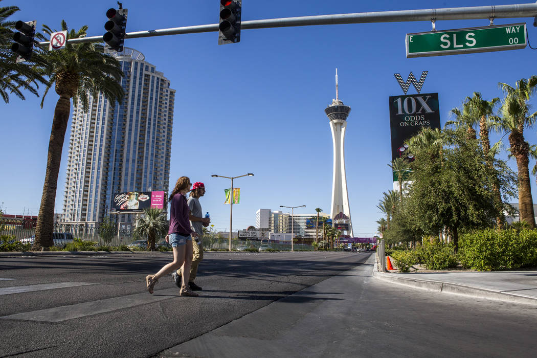 Pedestrians cross South Las Vegas Boulevard near the Stratosphere on Monday, June 12, 2017. Golden Entertainment, operators of the PT's Pubs chain is acquiring a company that owns four Nevada casi ...