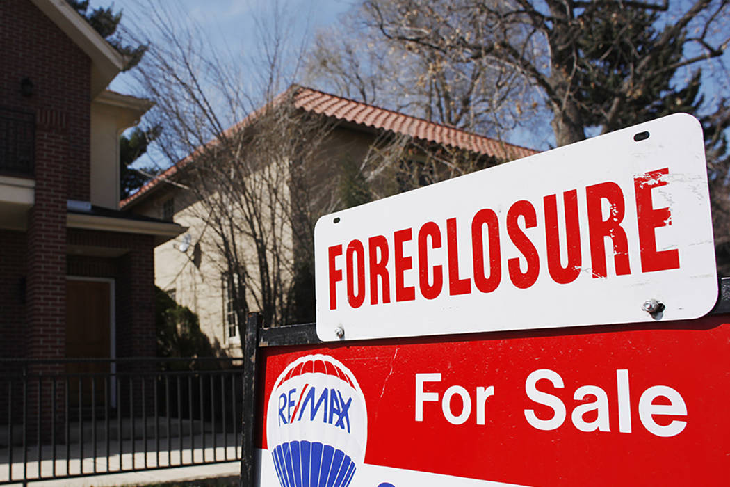 A foreclosure sign hangs in front of a Denver home on April 4, 2010. (David Zalubowski/AP)
