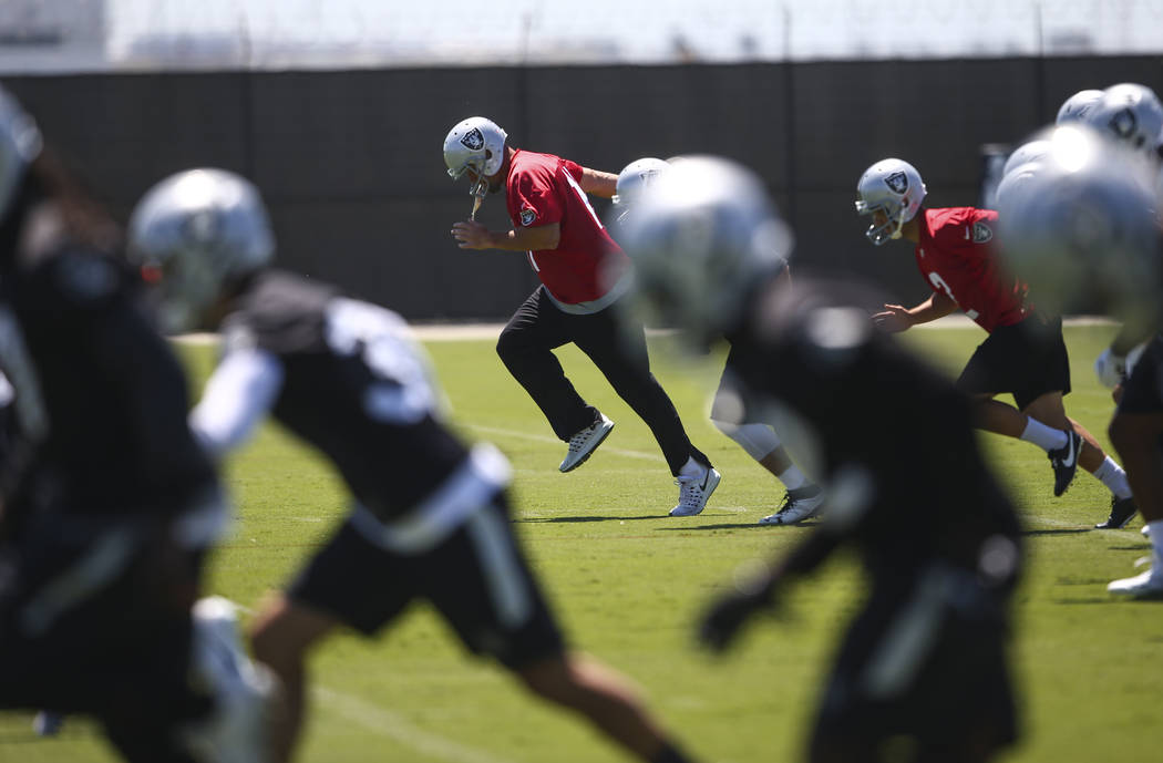 Oakland Raiders kicker Sebastian Janikowski, center, warms up during day two of a mini-camp at the Raiders headquarters and training facility in Alameda, Calif. on Wednesday, June 14, 2017. Chase  ...