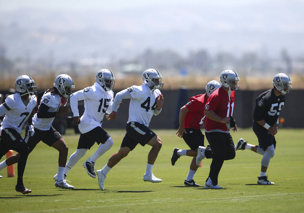 Oakland Raiders kicker Sebastian Janikowski (11) warms up with teammates during day two of a mini-camp at the Raiders headquarters and training facility in Alameda, Calif. on Wednesday, June 14, 2 ...