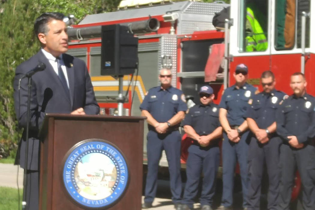 Gov. Brian Sandoval speaks Wednesday outside the State Capitol in Carson City before signing bills that will create a memorial for firefighters and put enhanced penalties in place for crimes again ...