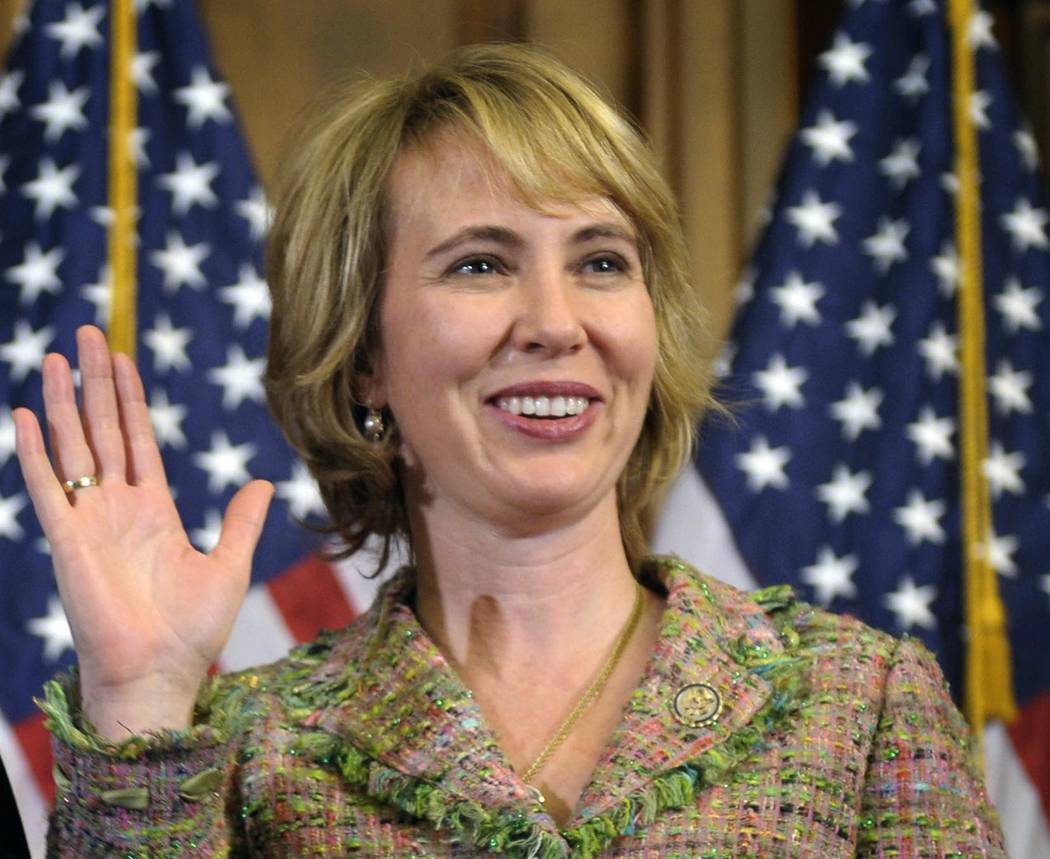 In this Jan. 5, 2011 file photo, Rep. Gabrielle Giffords, D-Ariz., takes part in a re-enactment of her swearing-in on Capitol Hill in Washington on Jan. 5, 2011. Three days later, she was shot in ...