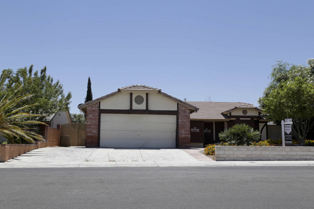 A boarded-up house is seen near Lone Mountain Road and Jones Boulevard in Las Vegas, Wednesday, June 28, 2017. Despite the improving housing market, Las Vegas officials are boarding up an increasi ...