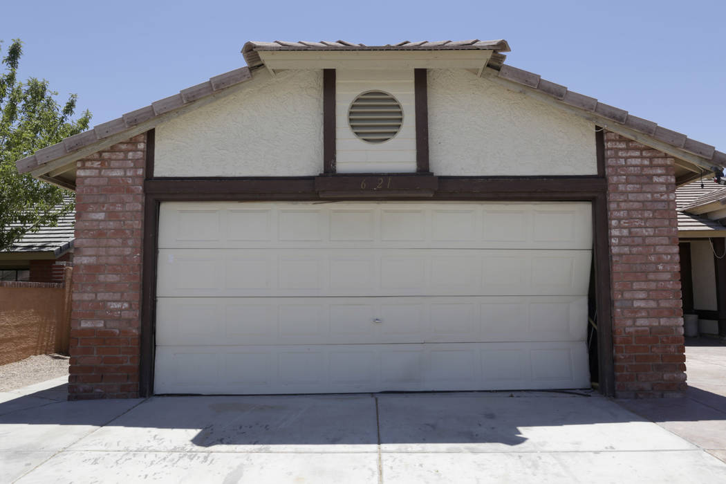 A boarded-up house is seen near Lone Mountain Road and Jones Boulevard in Las Vegas, Wednesday, June 28, 2017. Despite the improving housing market, Las Vegas officials are boarding up an increasi ...