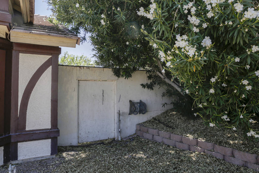 A boarded-up house is seen near Lone Mountain Road and Jones Boulevard in Las Vegas, Wednesday, June 28, 2017. Despite the improving housing market, Las Vegas officials are boarding up an increasi ...