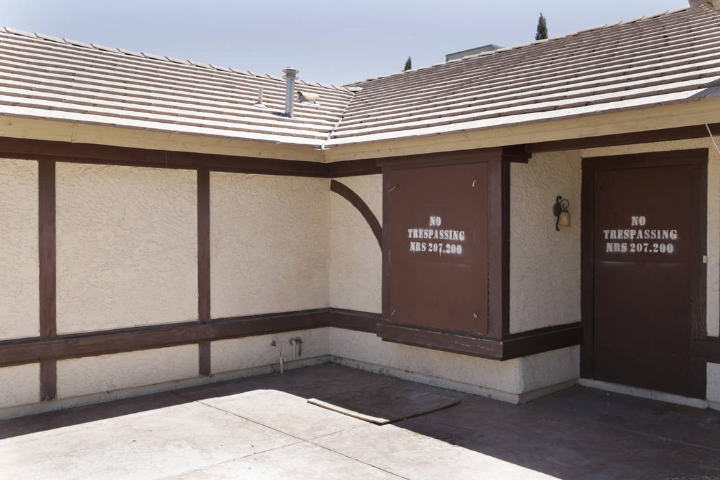 A boarded-up house is seen near Lone Mountain Road and Jones Boulevard in Las Vegas, Wednesday, June 28, 2017. Despite the improving housing market, Las Vegas officials are boarding up an increasi ...