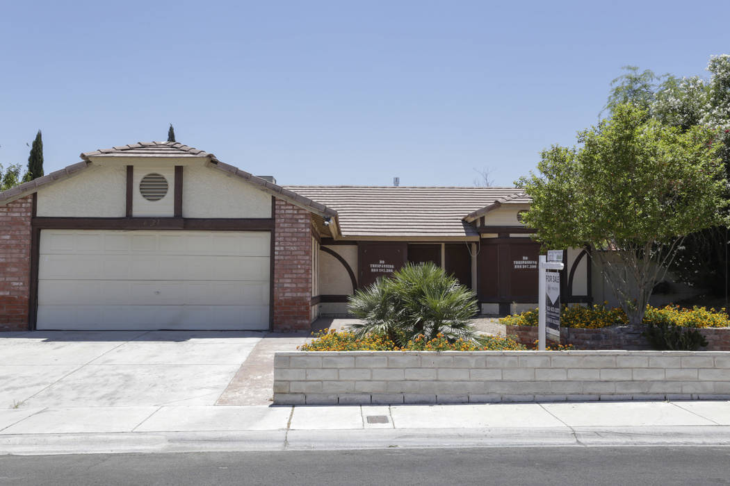 A boarded-up house is seen near Lone Mountain Road and Jones Boulevard in Las Vegas, Wednesday, June 28, 2017. Despite the improving housing market, Las Vegas officials are boarding up an increasi ...