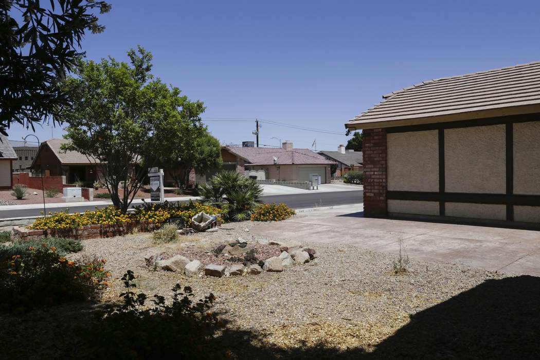 A boarded-up house is seen near Lone Mountain Road and Jones Boulevard in Las Vegas, Wednesday, June 28, 2017. Despite the improving housing market, Las Vegas officials are boarding up an increasi ...