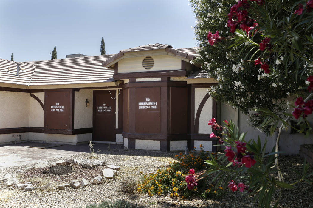 A boarded-up house is seen near Lone Mountain Road and Jones Boulevard in Las Vegas, Wednesday, June 28, 2017. Despite the improving housing market, Las Vegas officials are boarding up an increasi ...