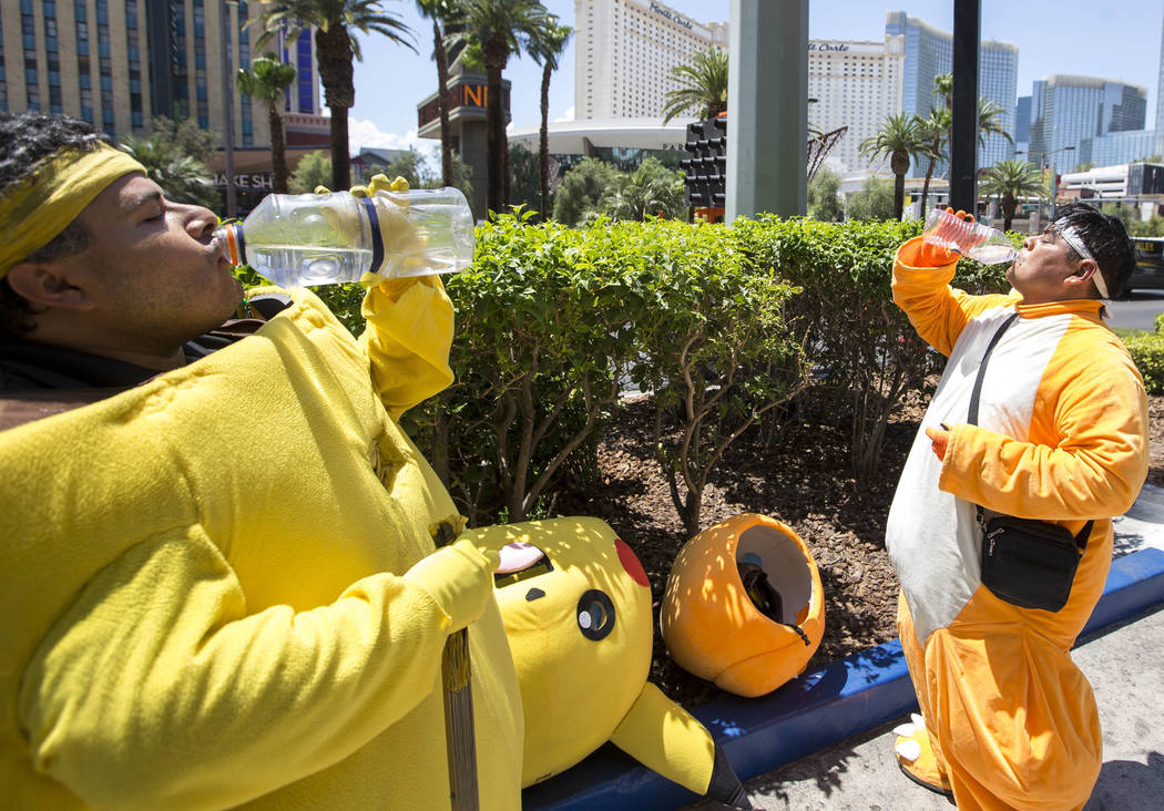 Street performers Ruben Osorio, left, and Raul Diaz take a break from posing for photos with tourists as Charmander and Pikachu along The Strip on Monday, June 19, 2017. Richard Brian Las Vegas Re ...