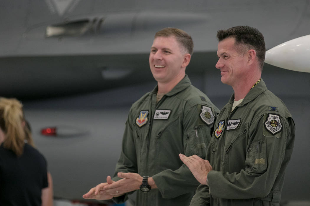 Lt. Col. Michael Blauser, left, and Col. Michael R. Drowley, right,  applaud at Nellis Air Force Base during an activation ceremony of an F-35A Lightning II aircraft on Tuesday, June 21, 2017, in  ...