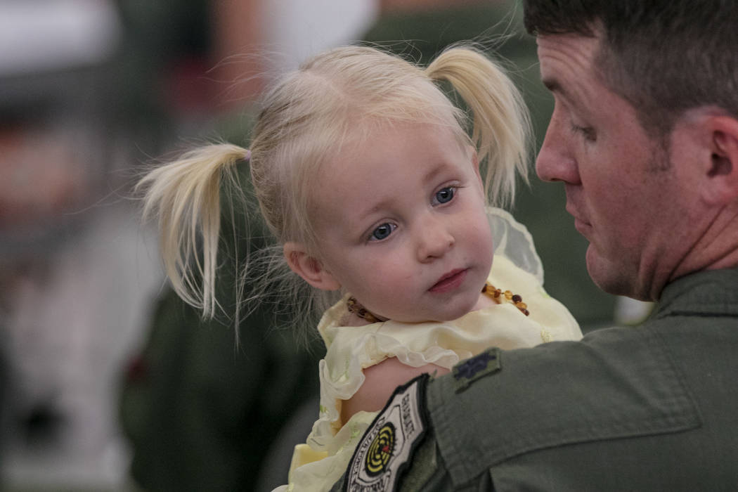 Peter Schnobrick holds his daughter Amelia, 15 months, at Nellis Air Force Base during an activation ceremony of an F-35A Lightning II aircraft on Tuesday, June 21, 2017, in Las Vegas. Morgan Lieb ...