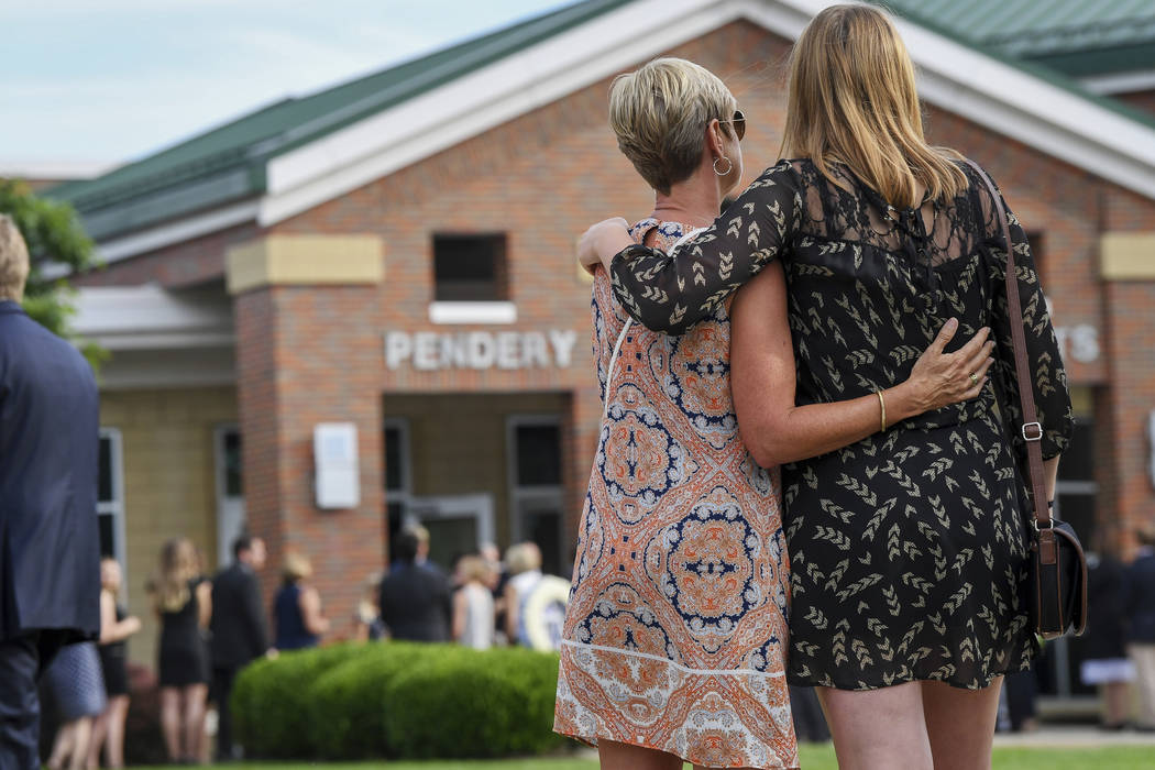 Mourners embrace as they arrive for the funeral of Otto Warmbier, Thursday, June 22, 2017, in Wyoming, Ohio. Warmbier, a 22-year-old University of Virginia undergraduate student who was sentenced  ...