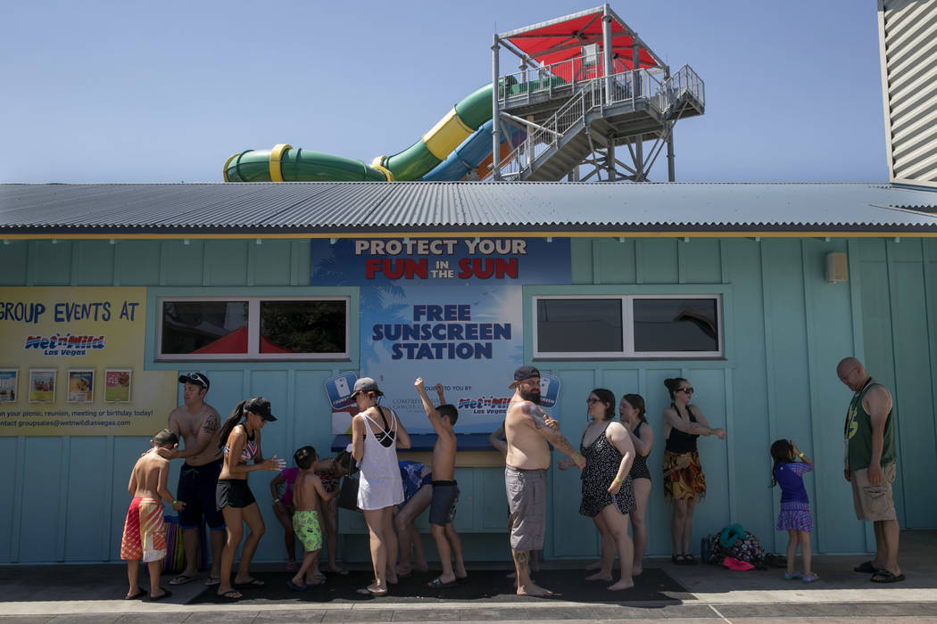 People apply sunscreen before enjoying a day at Wet n' Wild Las Vegas, Thursday, June 22, 2017. (Gabriella Angotti-Jones/Las Vegas Review-Journal) @gabriellaangojo