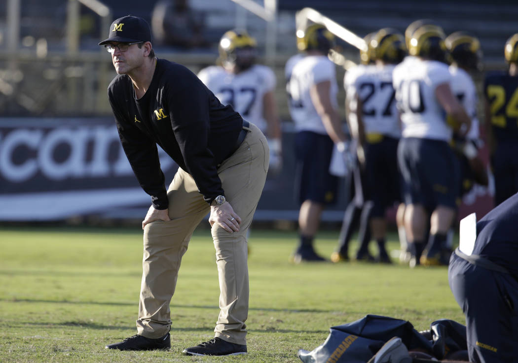 Michigan head coach Jim Harbaugh watches during NCAA college football practice, Tuesday, Dec. 27, 2016, in Miami. Michigan plays Florida State in the Orange Bowl Friday. (AP Photo/Lynne Sladky)