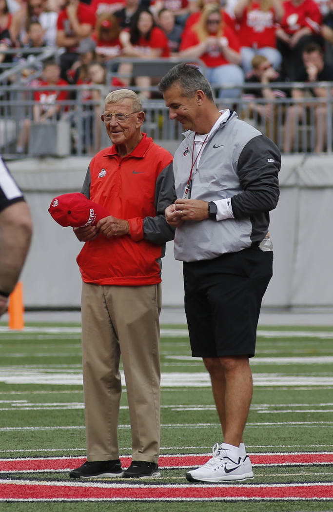 Ohio State head coach Urban Meyer, right, stands with Lou Holtz, former college football coach, as Holtz is recognized as the honorary captain of the Scarlet team during Ohio State's NCAA college  ...