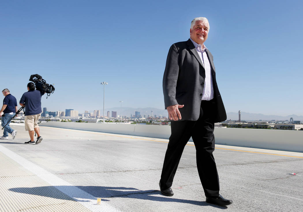 Clark County Commission Chairman Steve Sisolak walks on the new flyover ramp that links the southbound Airport Connector to the eastbound 215 Beltway near McCarran International Airport in Las Veg ...