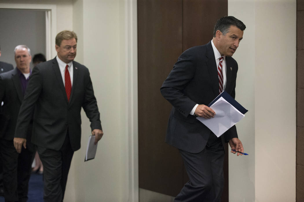 Nevada Gov. Brian Sandoval, right, followed by Sen. Dean Heller, R-Nev., during a press conference where the senator announced he will vote no on the proposed GOP healthcare bill at the Sawyer Bui ...