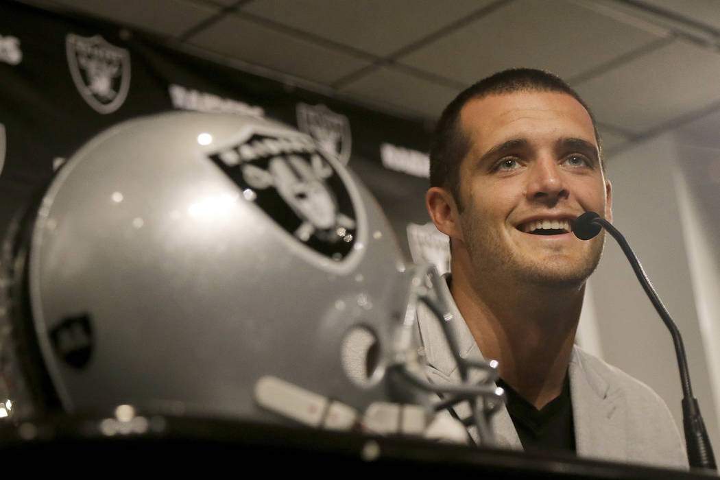 Oakland Raiders quarterback Derek Carr smiles while speaking at a news conference in Oakland, Calif., Friday, June 23, 2017. Carr finalized a five-year contract extension that will keep him with t ...