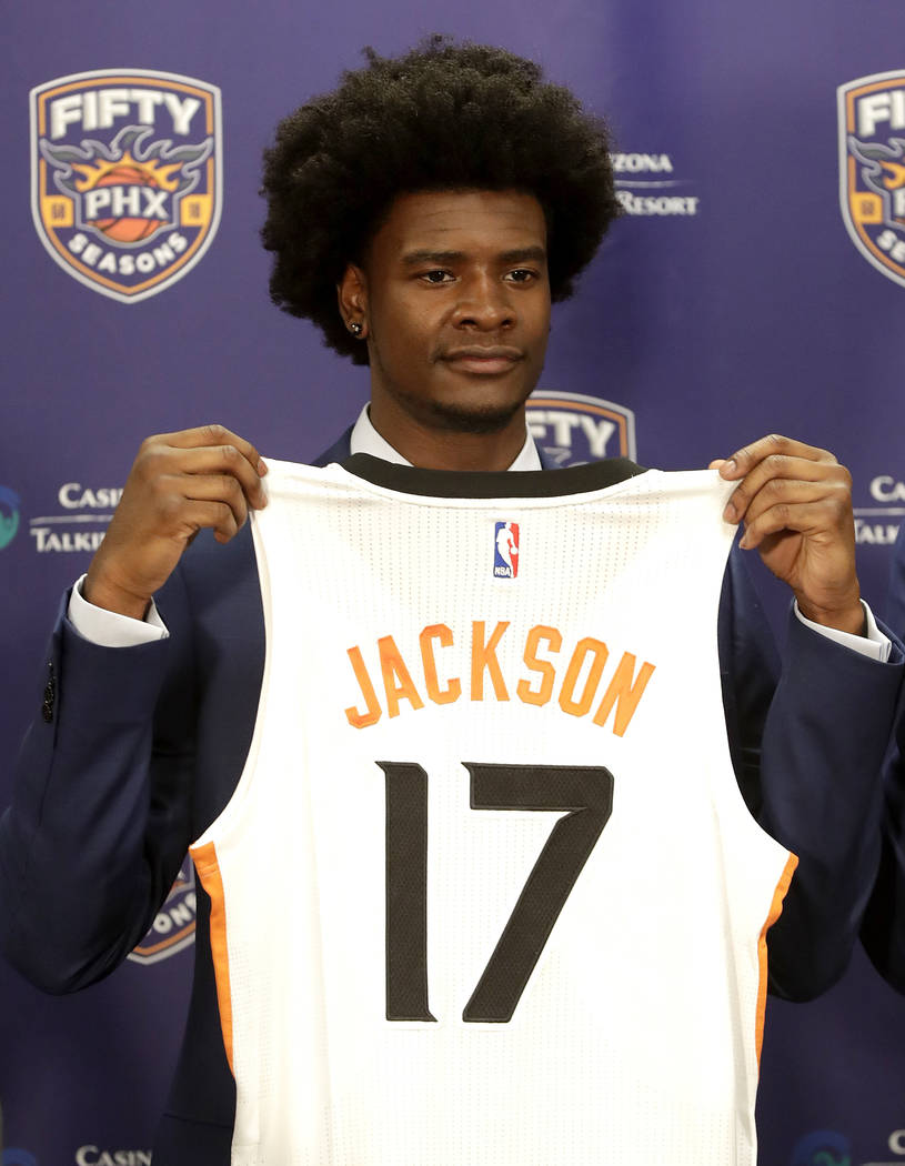Phoenix Suns first round NBA basketball draft pick Josh Jackson holds his jersey, Friday, June 23, 2017, in Phoenix. (AP Photo/Matt York)