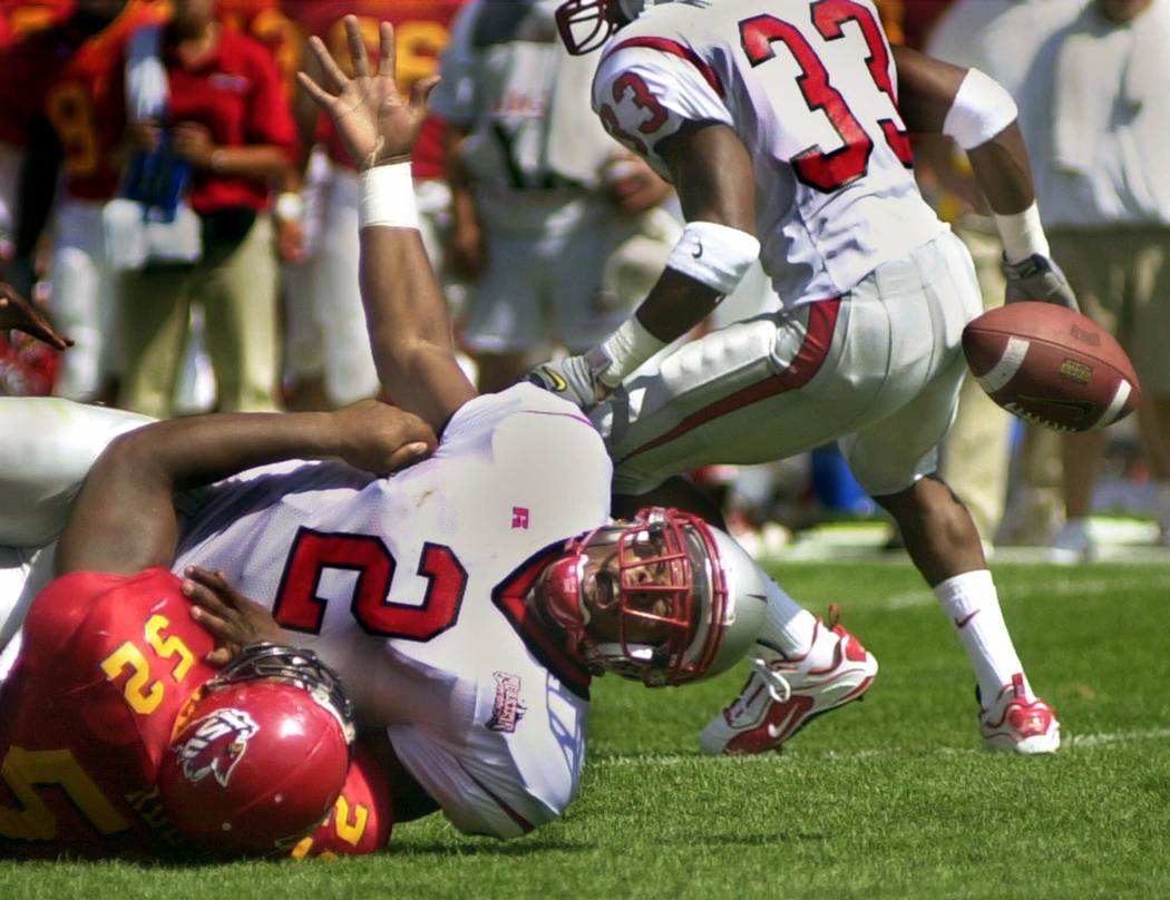 UNLV quarterback Jason Thomas (2) watches the ball bounce away after a tackle by Iowa State's James Reed in the first half Saturday, Sept. 9, 2000, in Ames, Iowa. (AP Photo/Steve Pope)