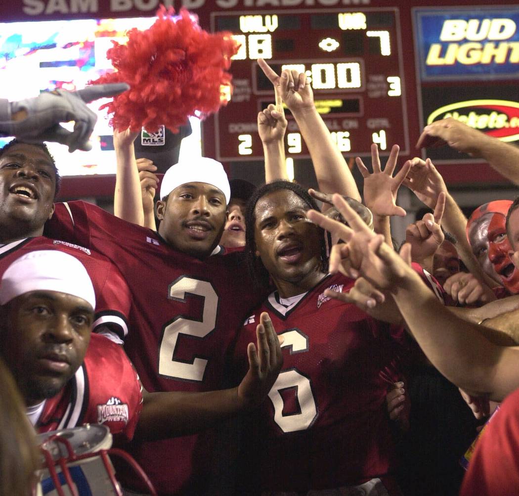 UNLV quarterback Jason Thomas (2) and wide receiver Nate Turner (6) celebrate a 38-7 victory over Nevada with fans on Saturday, Oct. 7, 2000, in Las Vegas. (AP Photo/Jeff Klein)
