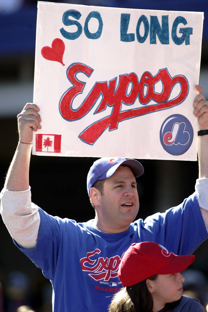 A Montreal Expos fan holds up a sign at the Expos final game as the Montreal Expos against the New York Mets, Sunday, Oct. 3, 2004, at Shea Stadium in New York. (AP Photo/Ed Betz)