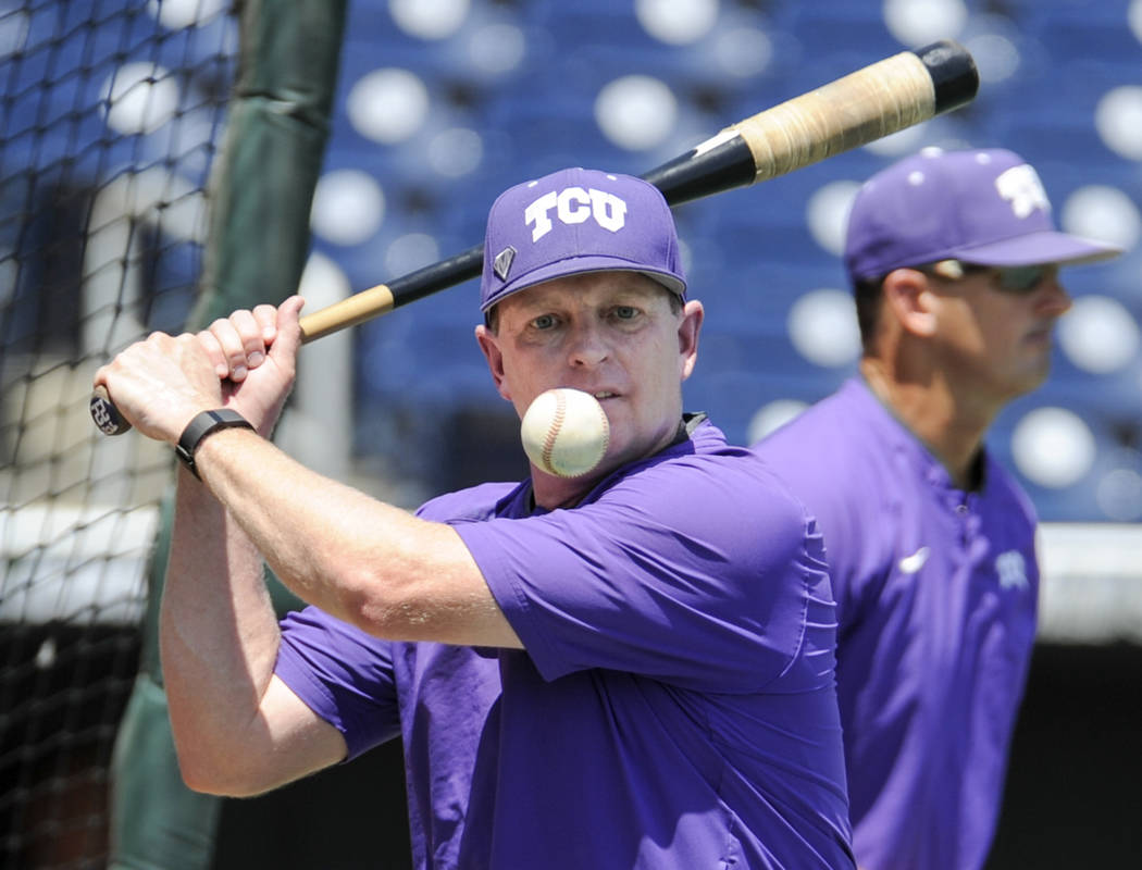 TCU coach Jim Schlossnagle hits a ball during practice at TD Ameritrade Park in Omaha, Neb., Friday, June 17, 2016. TCU will play Texas Tech on Sunday in the NCAA men's baseball College World Seri ...