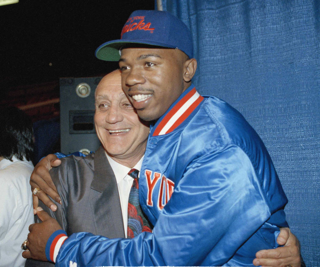 UNLV basketball coach Jerry Tarkanian hugs former UNLV player Greg Anthony after Anthony was chosen by the New York Knicks in the first round of the NBA draft at New York's Madison Square Garden,  ...
