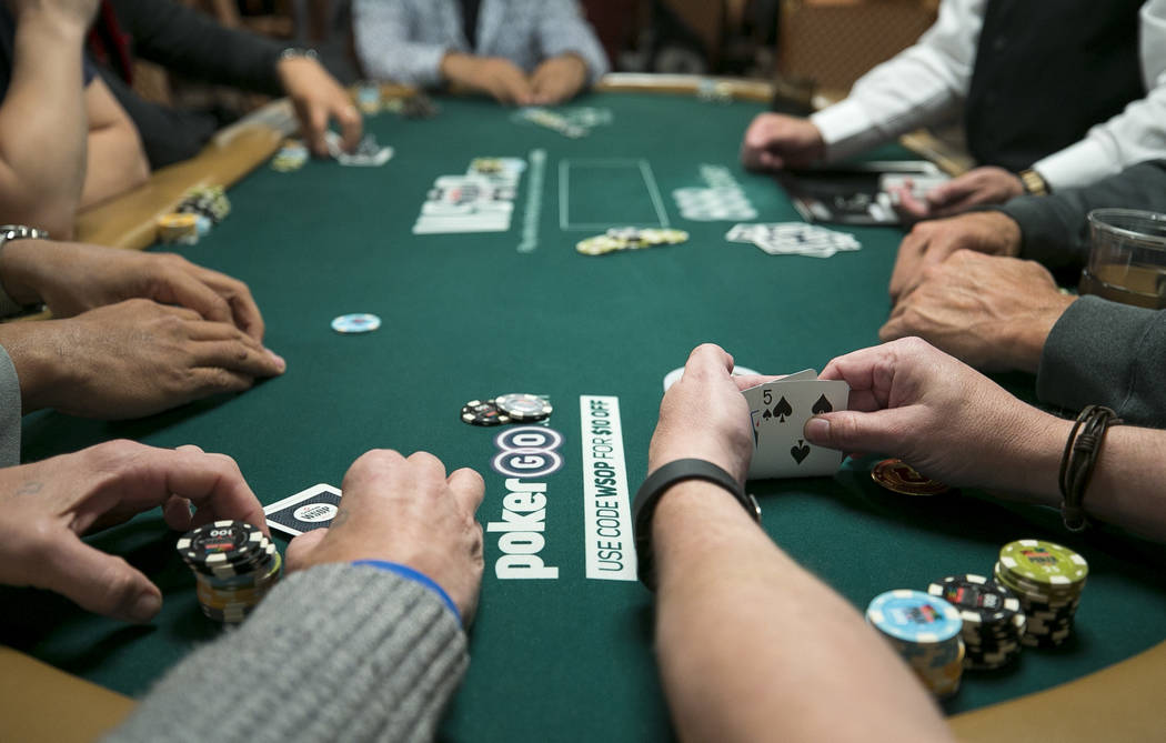 A poker player checks his cards during the World Series of Poker on Monday, June 26, 2017, at the Rio hotel-casino, in Las Vegas. (Richard Brian/Las Vegas Review-Journal) @vegasphotograph