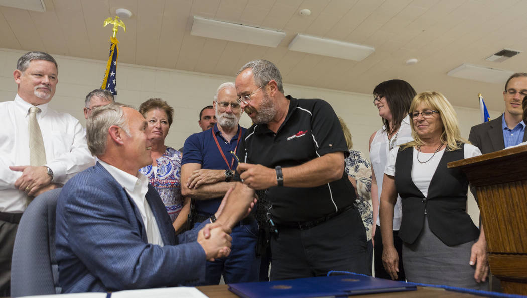 U.S. Secretary of the Interior Ryan Zinke, left, shakes Chairman Dan Schinhofen of the Board of County Commissioners at the Bob Ruud Community Center in Pahrump, Monday, June 26, 2017. Elizabeth B ...