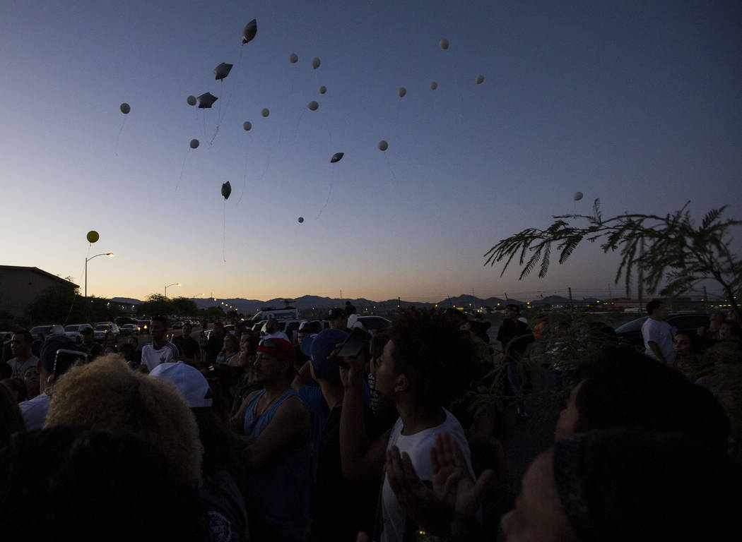 Balloons are released during a candlelight vigil for teenagers Oscar Ayala and Moises Rivera, who both died in a crash caused by a drunk driver this past Saturday, at Marion Drive and Judah Avenue ...