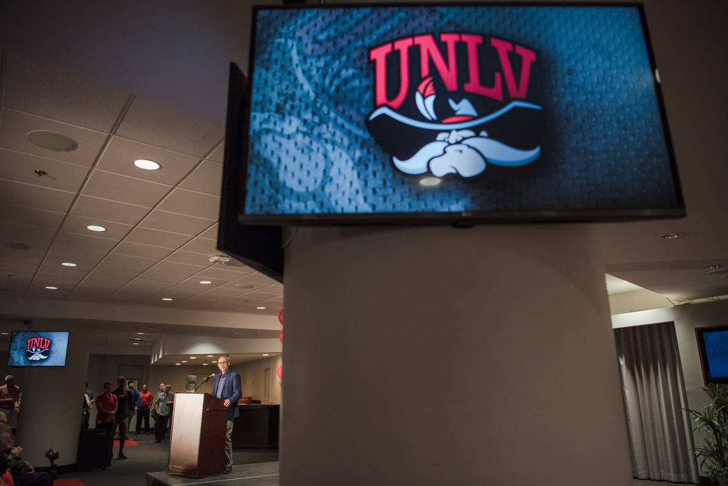 Dan Price, President of Adrenalin Inc., discusses the design process of the new UNLV logo at the UNLV Thomas & Mack Center, with the old logo on display on the monitors, on Wednesday, June 28. ...
